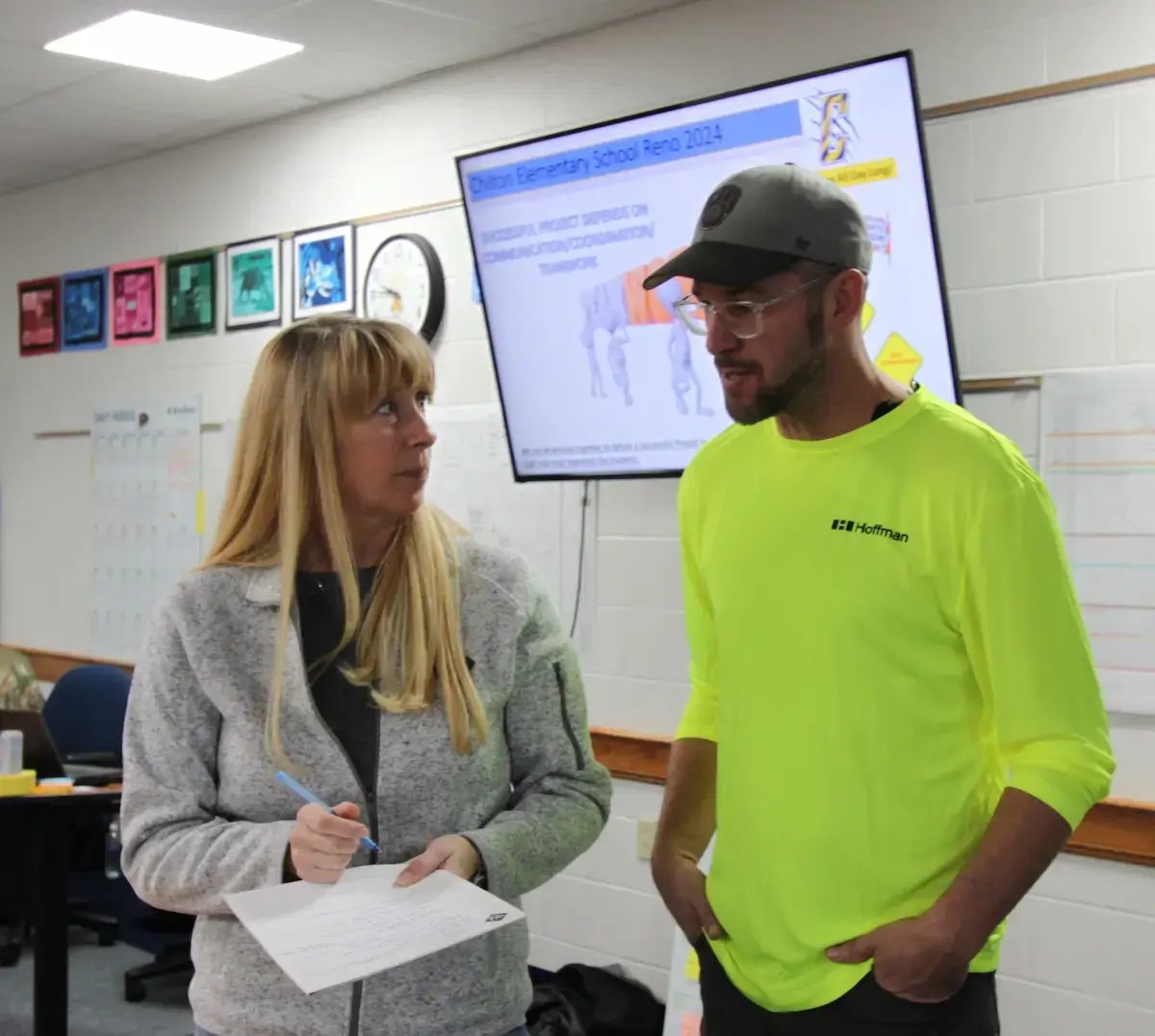 Hoffman employees discussing a project