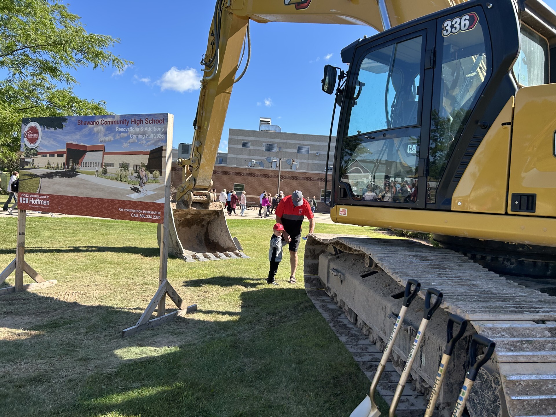 Community Members Explore the Construction Equipment After Ceremony