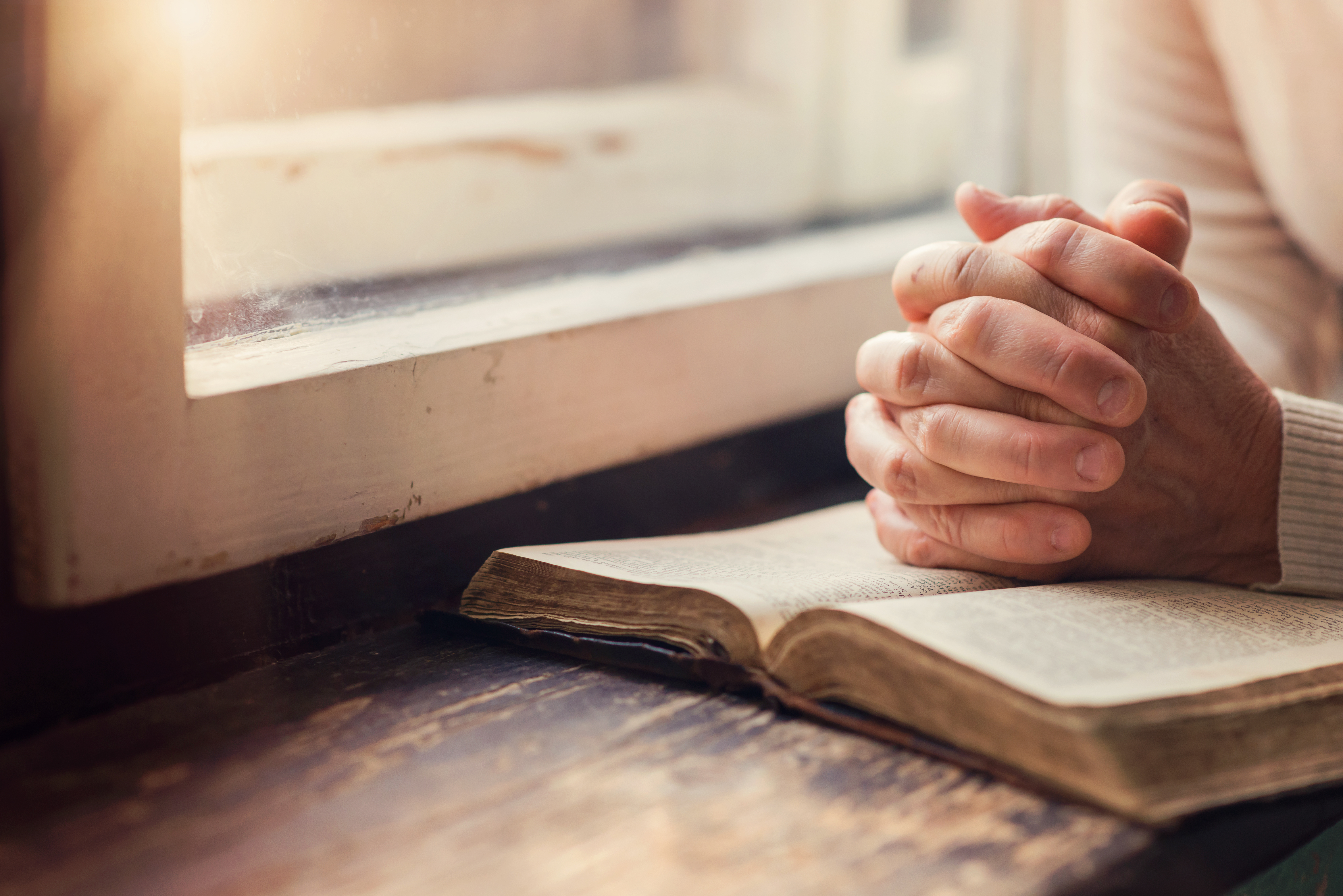 graphicstock-hands-of-an-unrecognizable-woman-with-bible-praying_S0xovwXpWb